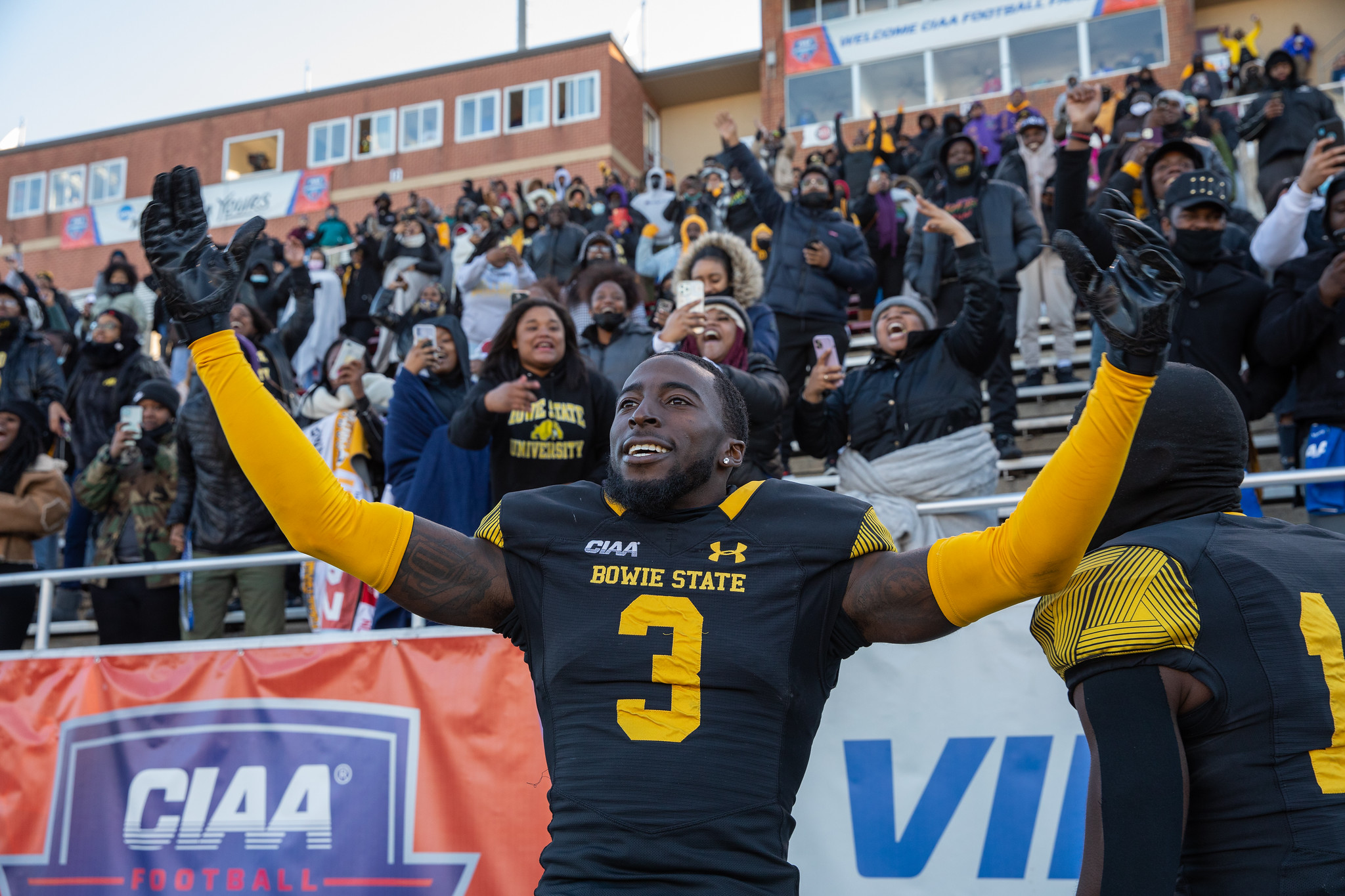 football player with arms up in celebration