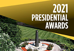 campus scene with torch and greenery text 2021 presidential awards