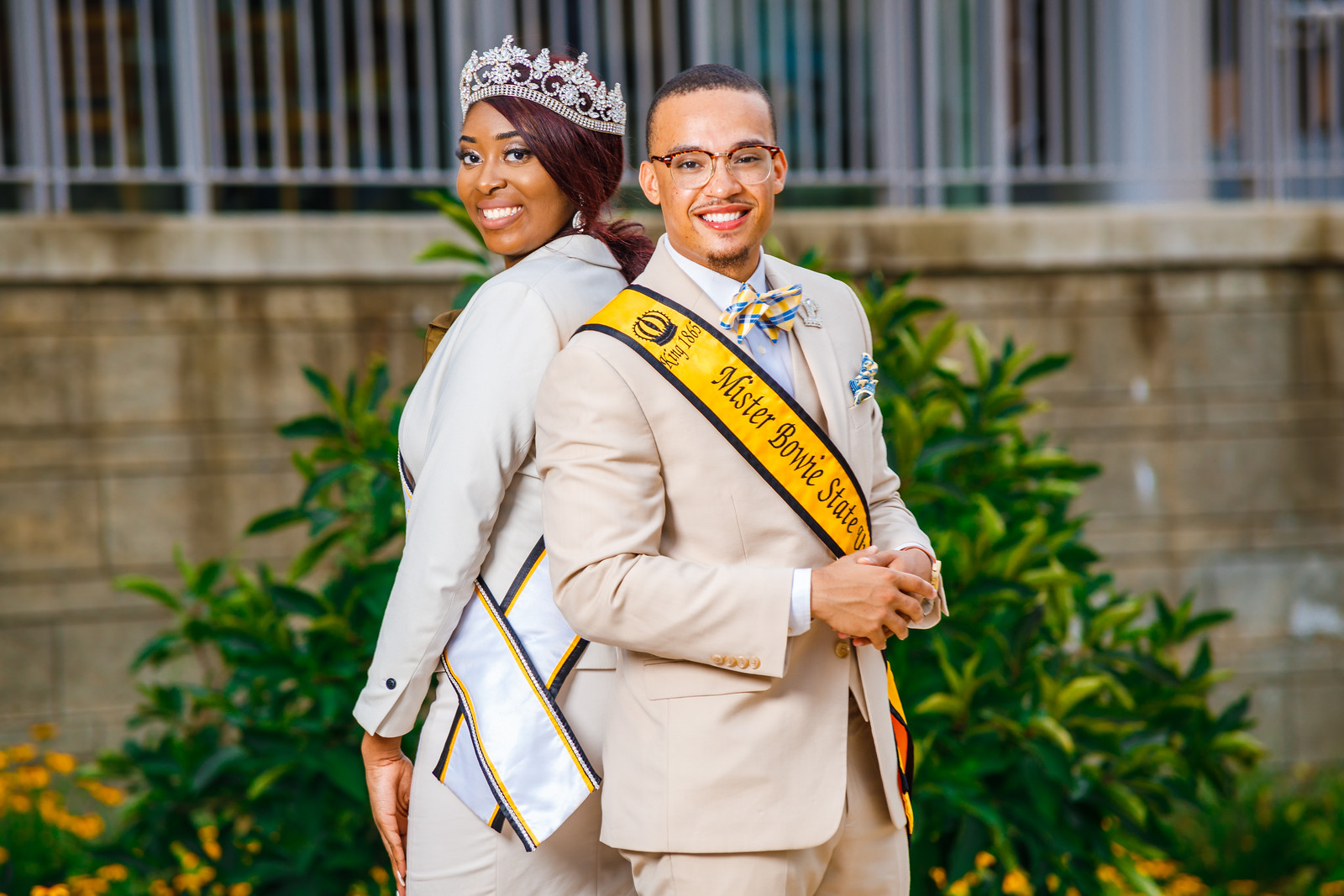 Monique Scott wearing a corwn stands back-to-back with DeRonte Craig