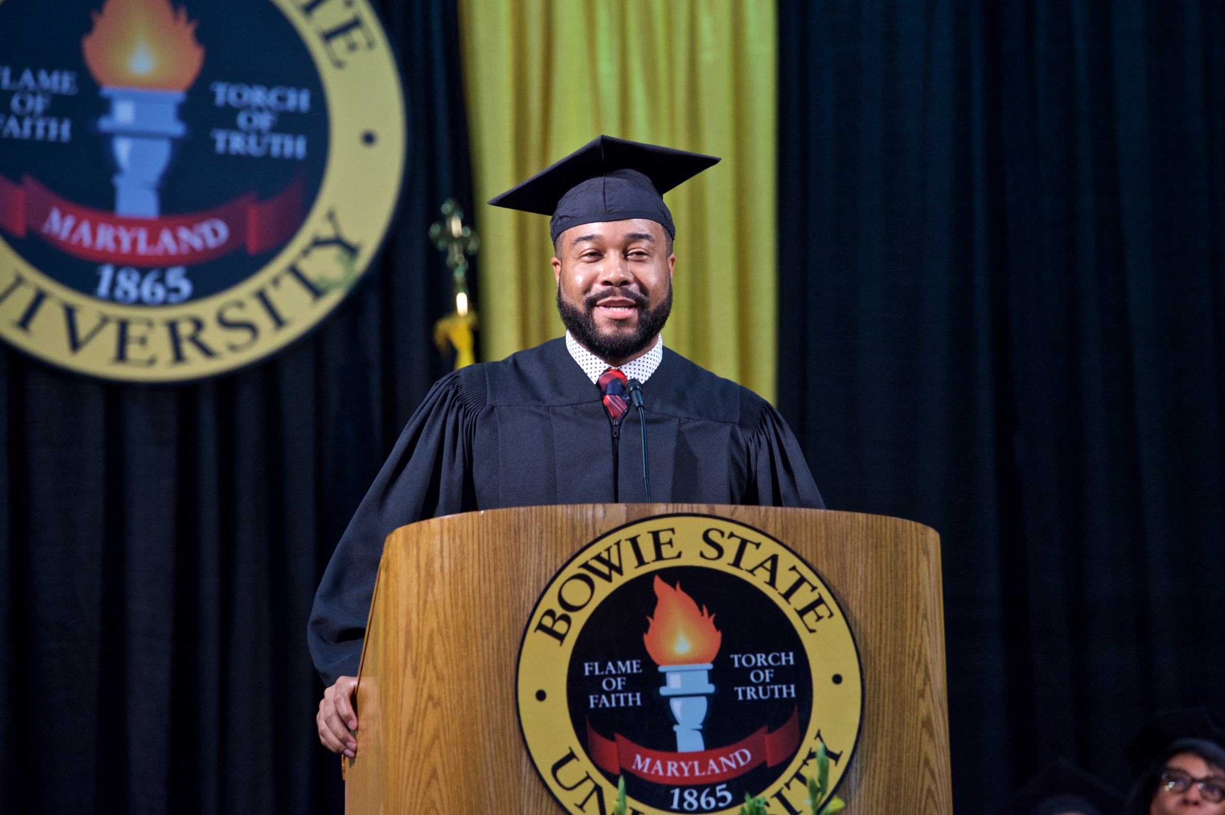 Dior Ginyard at podium with BSU seal