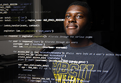 Male student looks upward as computer code is written across his face